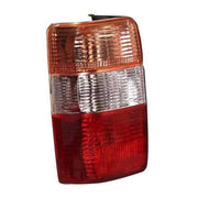 Red tail light assembly for Toyota Qualis, models 1999-2004, with a clear and red-tinted lens.