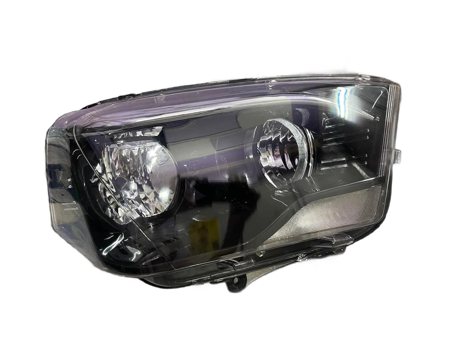 A white K D brand headlight for Mahindra Scorpio vehicle, without projector and with a clear lens.