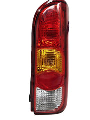 Red tail light for Maruti Eeco vehicle, featuring a clear lens and a yellow-red reflector.