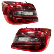 A pair of red tail lights for a Maruti Suzuki Baleno, featuring clear lens section and deep red housing.