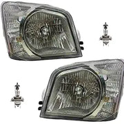 Two car headlights and two halogen bulbs on a white background