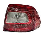 Red tail light assembly for Skoda Rapid (2011-2016) wrapped in plastic, with a clear lens and a red-tinted cover.