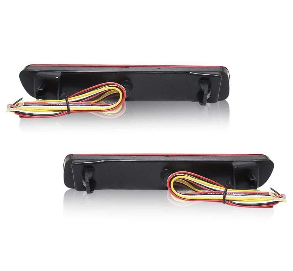 A pair of red K D Matrix rear bumper reflectors for Maruti vehicles, featuring a clear acrylic lens and a red-black-clear design.