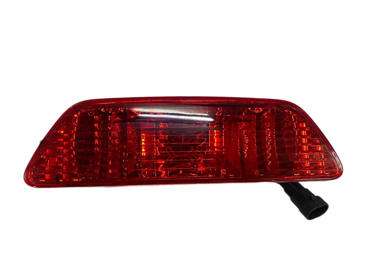 Red rear bumper light for vehicles, with a glass lens and black connector.