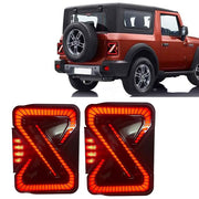 A pair of smoky black LED taillights designed for the Mahindra THAR, displayed in isolation and installed on a vehicle.