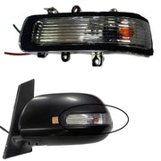 A black side mirror indicator for a vehicle, featuring a glass lens and built-in lighting, alongside an illustration of how it is installed on a vehicle.