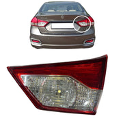 Car tail light assembly with a car in the background