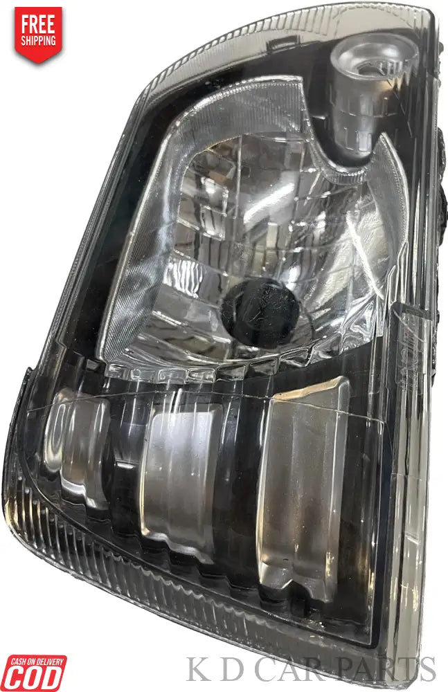 Headlight assembly for Maruti 800 Type 3, featuring a clear lens and reflective interior, with a black housing.