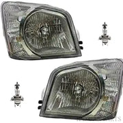 Two car headlights and two halogen bulbs on a white background