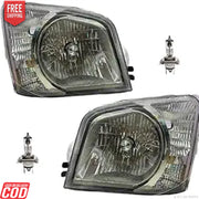 Two car headlights and two halogen bulbs on a white background