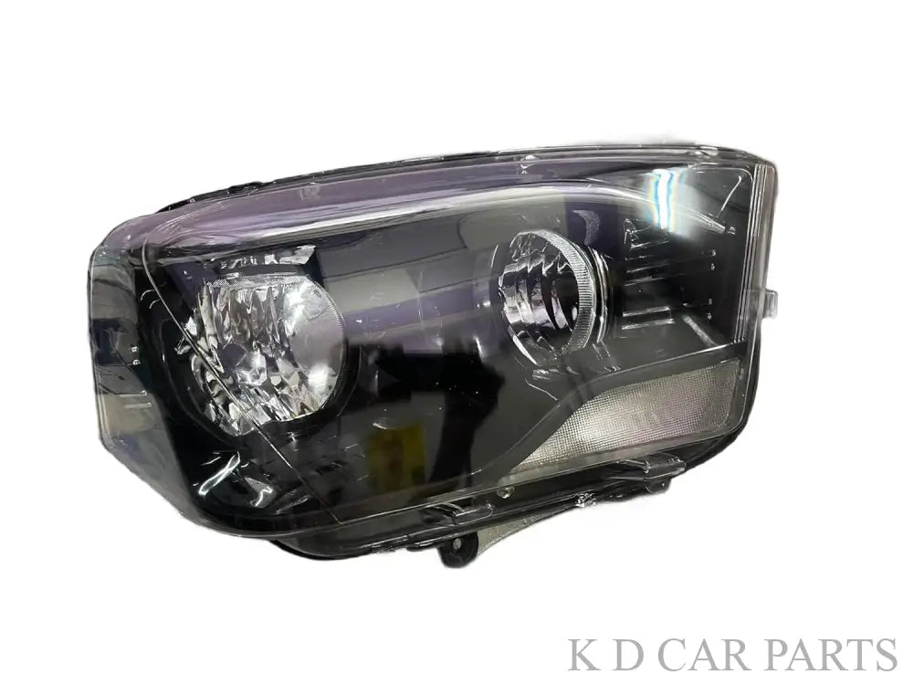 A white K D brand headlight for Mahindra Scorpio vehicle, without projector and with a clear lens.