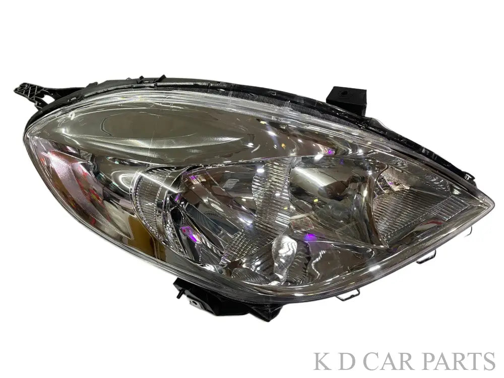 A pair of K D brand headlight units for Nissan Sunny, featuring clear lenses and halogen bulbs, without adjustable motors.