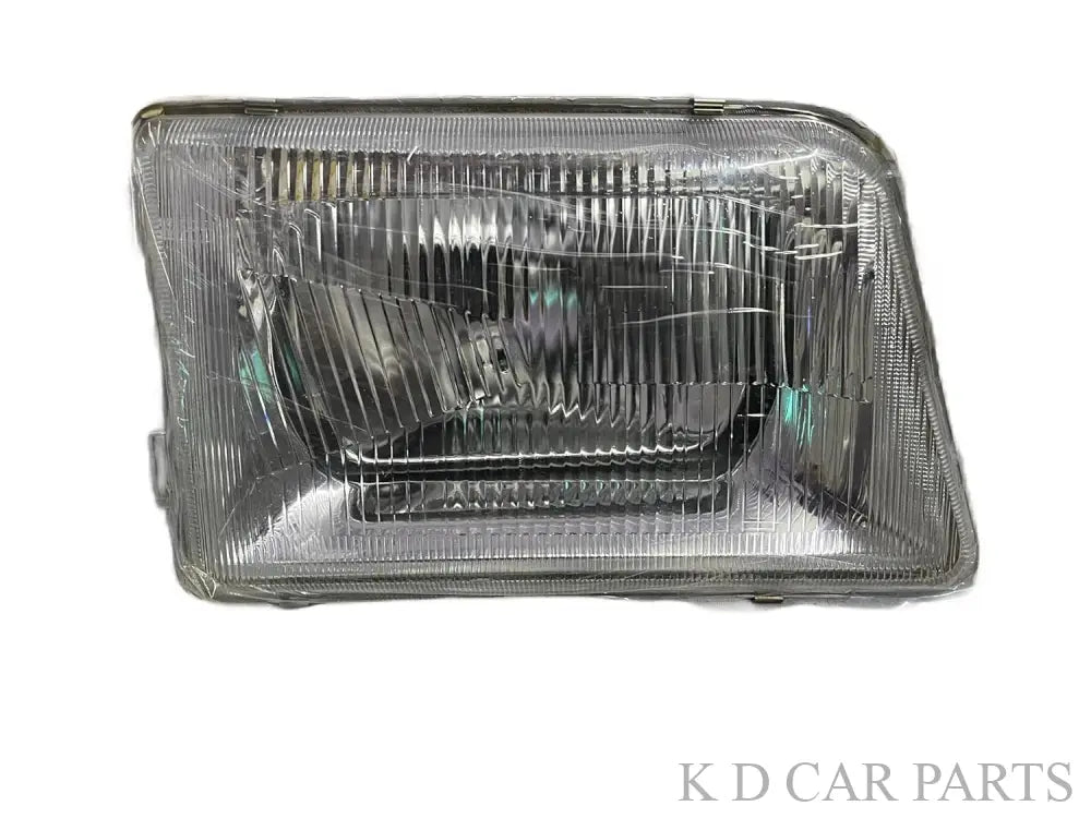 A single headlight for Tata 207 DI vehicle model, featuring a clear, water-resistant, break-proof glass lens with a silver-colored reflector.