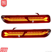 A pair of red K D Matrix rear bumper reflectors for Maruti vehicles, featuring a clear acrylic lens and a red-black-clear design.