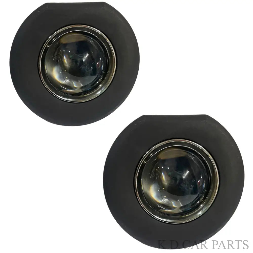 Two black round lights with chrome centers on a white background