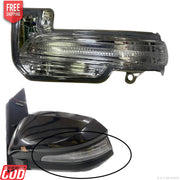 A K D brand side mirror indicator for vehicles, showing both the mirror assembly with built-in turn signal and the mirror's reflection in a separate image.