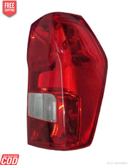 Red tail light assembly for a vehicle, featuring clear lens and reflector elements.