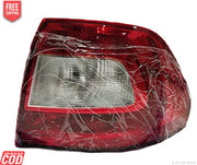 Red tail light assembly for Skoda Rapid (2011-2016) wrapped in plastic, with a clear lens and a red-tinted cover.