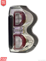 A white, halogen K D tail light for Mahindra Scorpio S10.