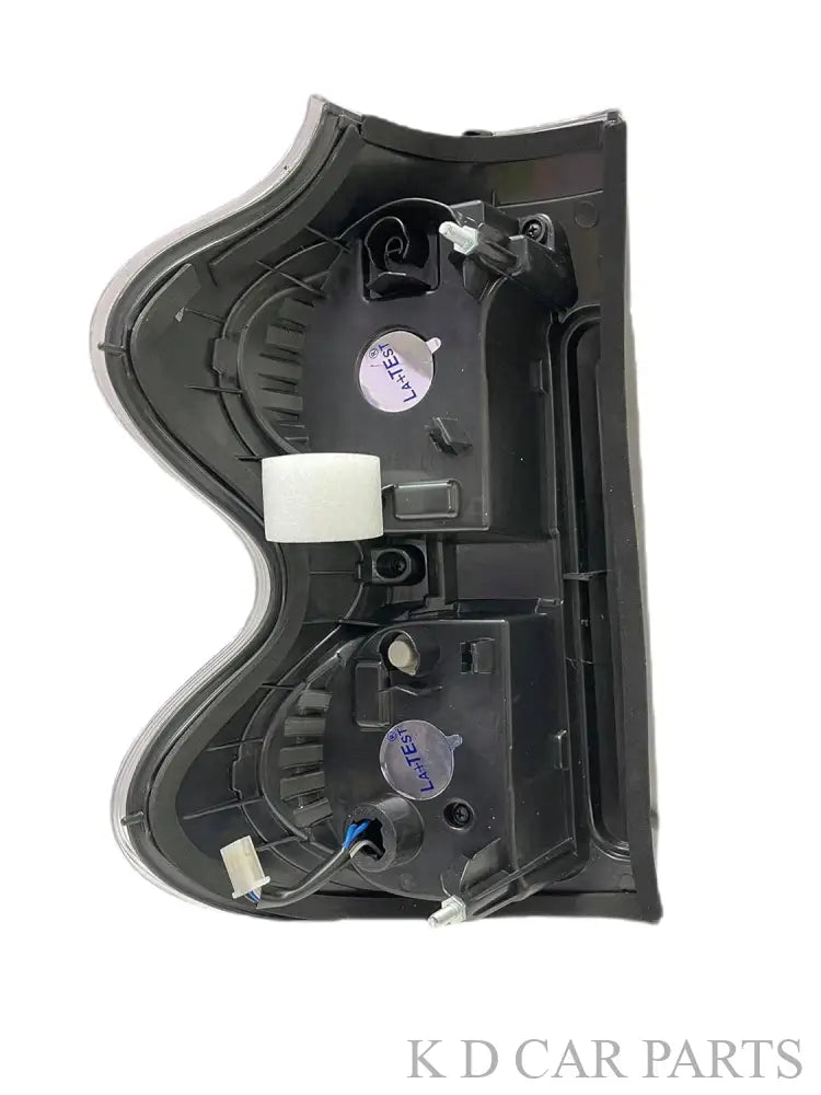 A white, halogen K D tail light for Mahindra Scorpio S10.