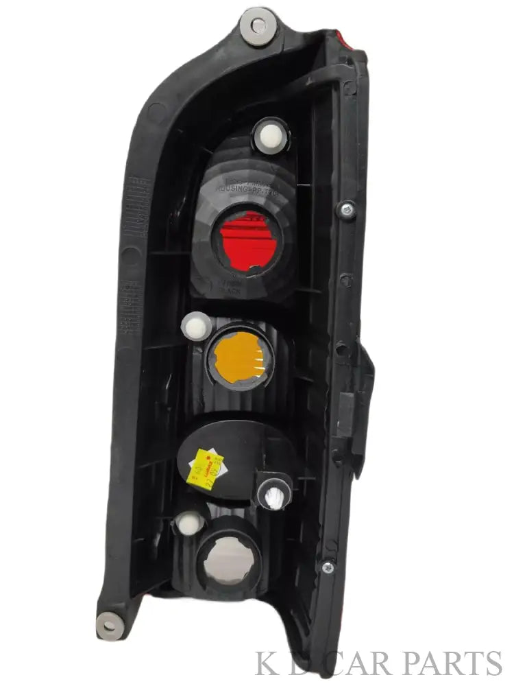 Red tail light for Maruti Eeco vehicle, featuring a clear lens and a yellow-red reflector.