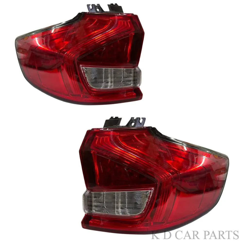 A pair of red and clear taillight assemblies for a Maruti Ertiga vehicle, featuring integrated brake light, tail light, and reverse light sections.