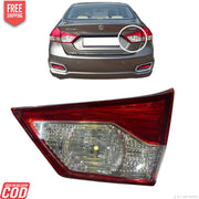Car tail light assembly with a car in the background