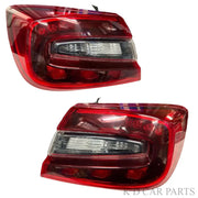 A pair of red tail lights for a Maruti Suzuki Baleno, featuring clear lens section and deep red housing.