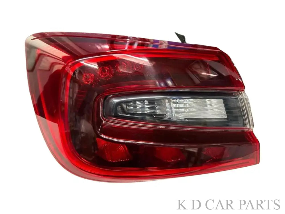A pair of red tail lights for a Maruti Suzuki Baleno, featuring clear lens section and deep red housing.